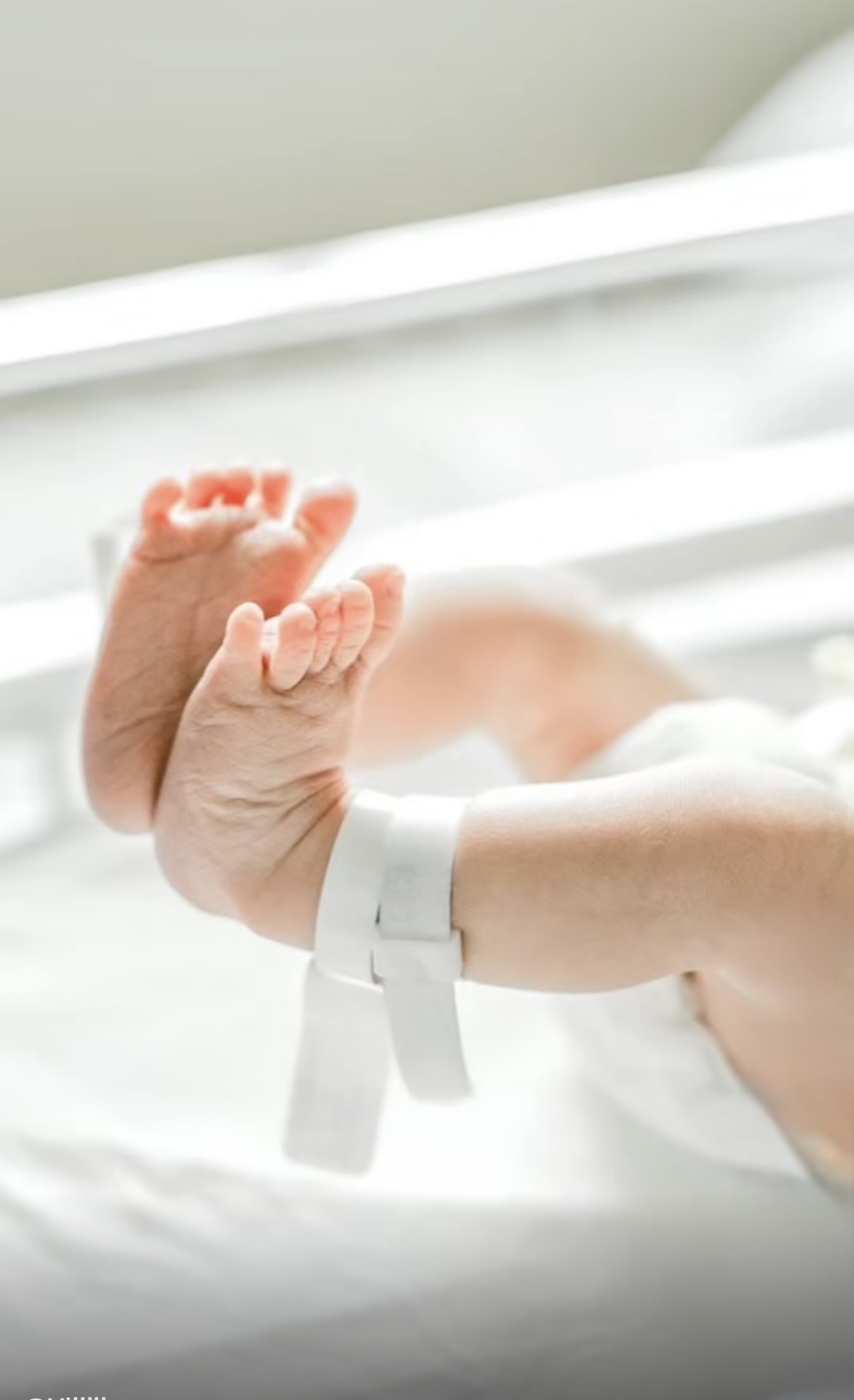 Newborn feet in soft light