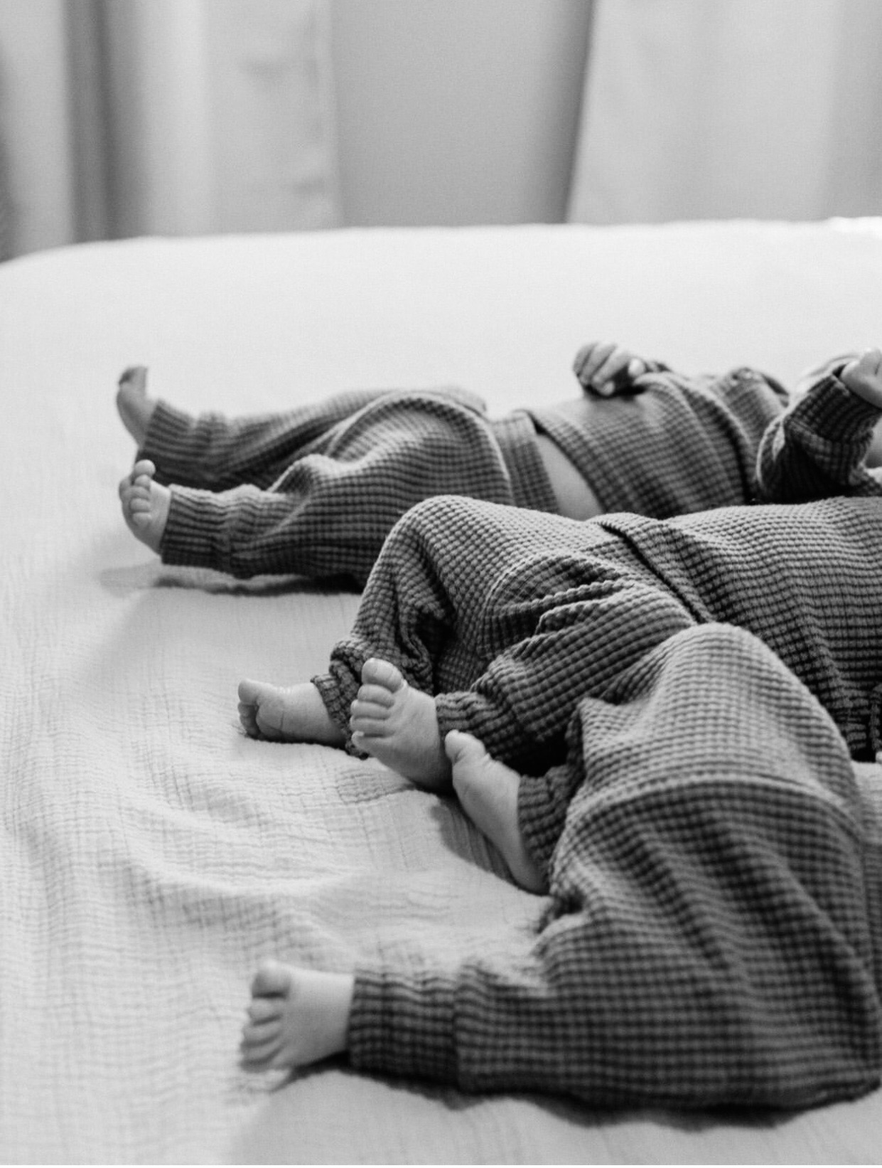 Black and white detail of newborn twins