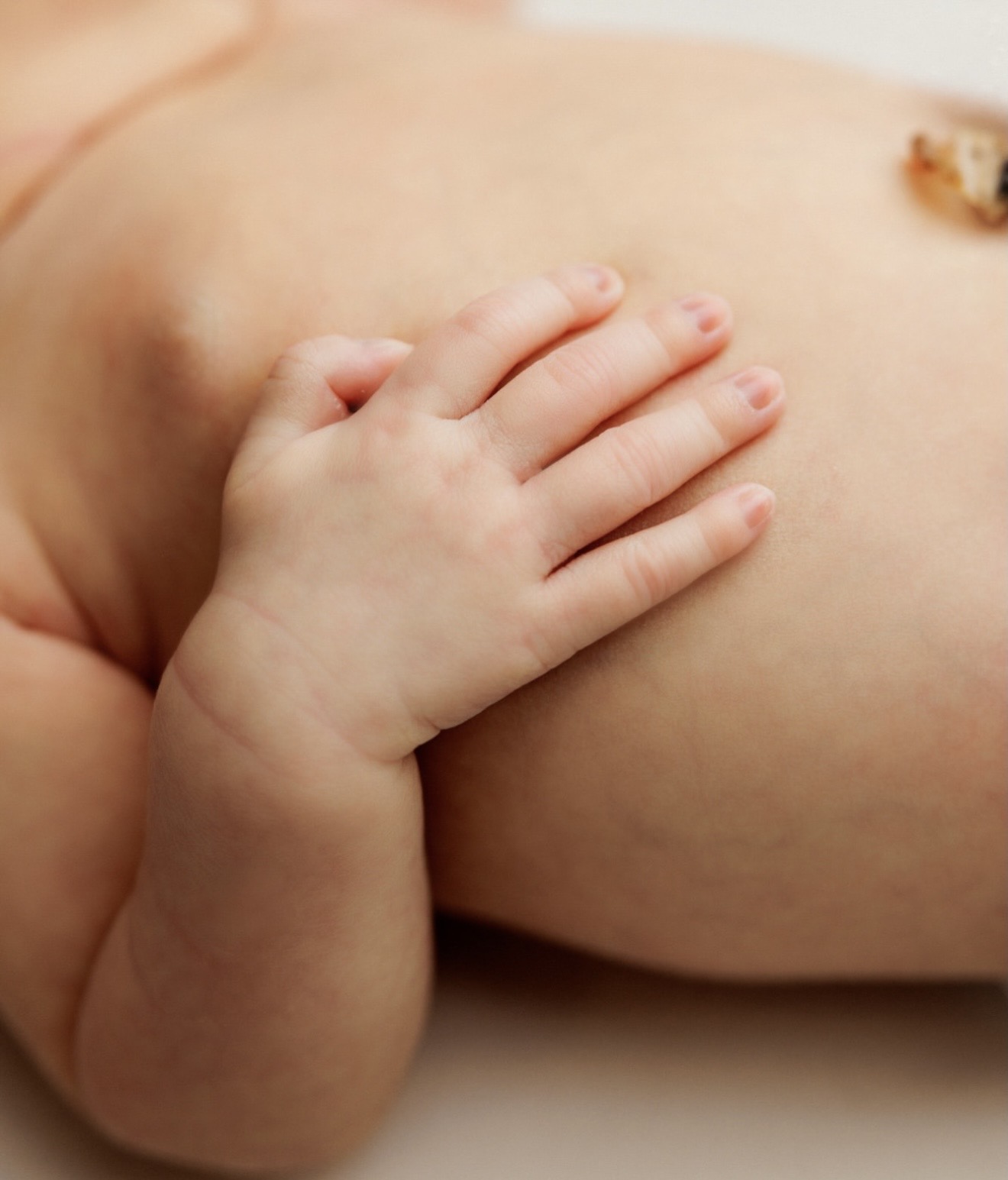 Newborn hand resting gently