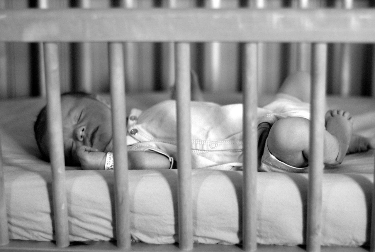 Newborn sleeping in a crib