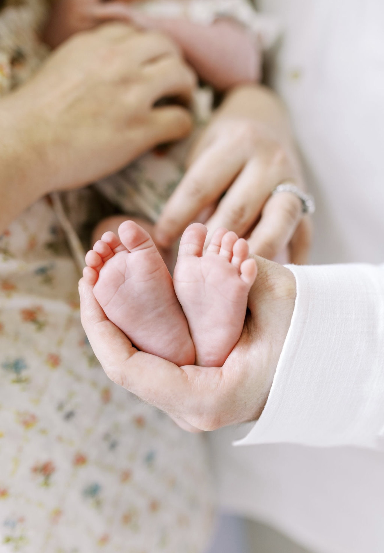 Newborn feet cradled in hands