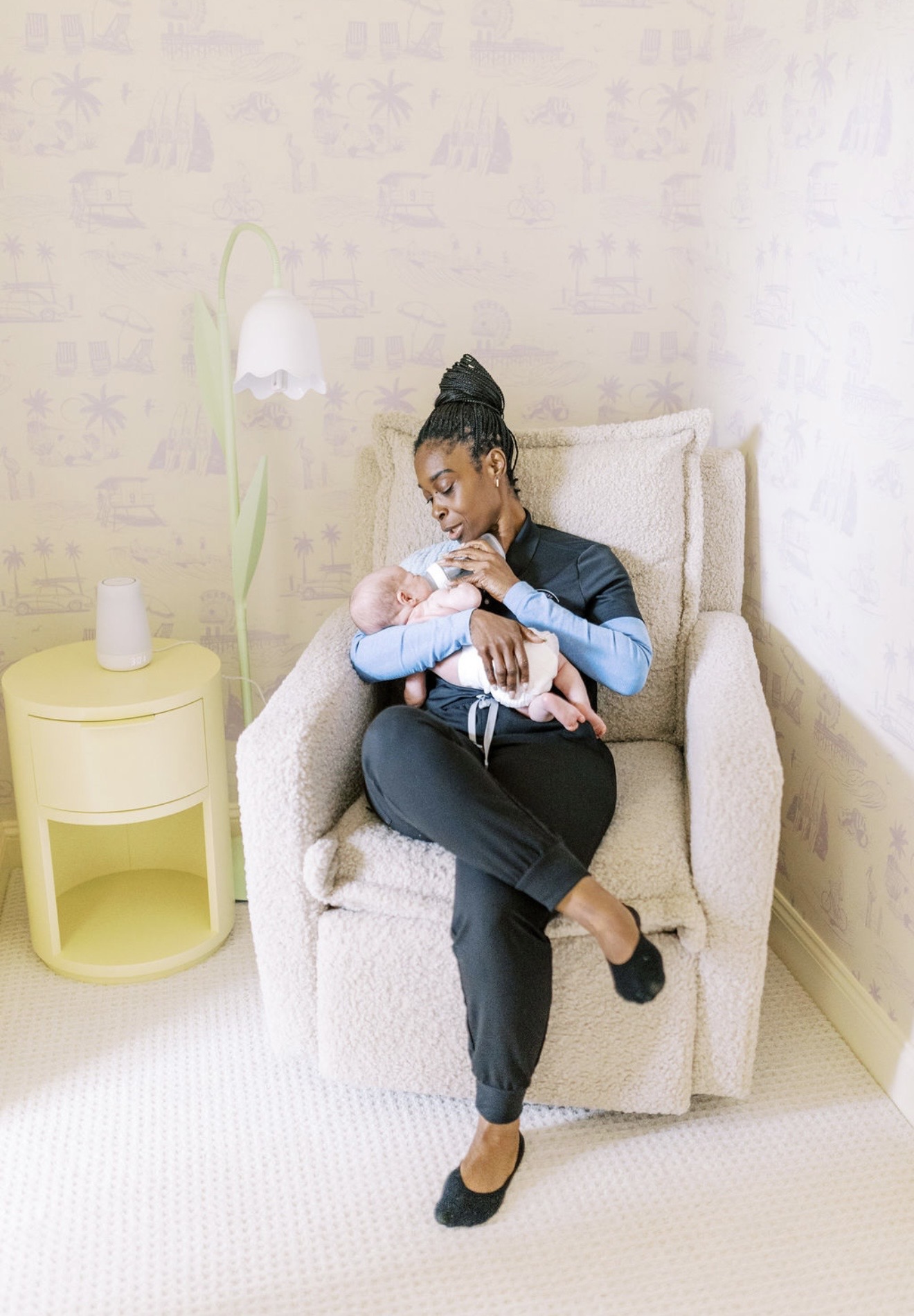 Kim Morgan Smart feeding a newborn in a nursery